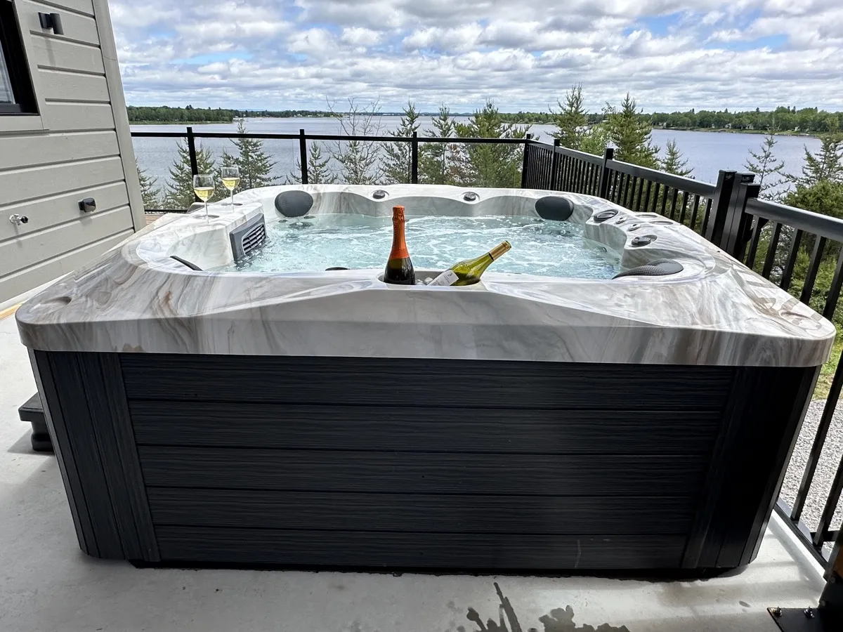 Thermēa spa on a lakefront deck on a sunny summer day